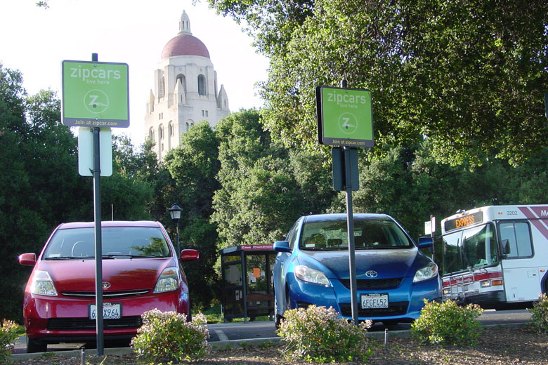 Photo of Zip Cars on the Oval with Hoover Tower in the background. 