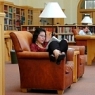 A student enjoys one of the comfortable chairs in the Lane Reading Room