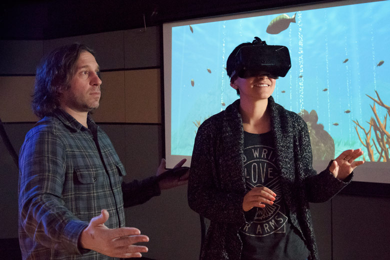 Jeremy Bailenson with student wearing virtual reality headset / L.A. Cicero