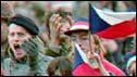 People cheer in Prague in 1989 as a non-communist government is announced