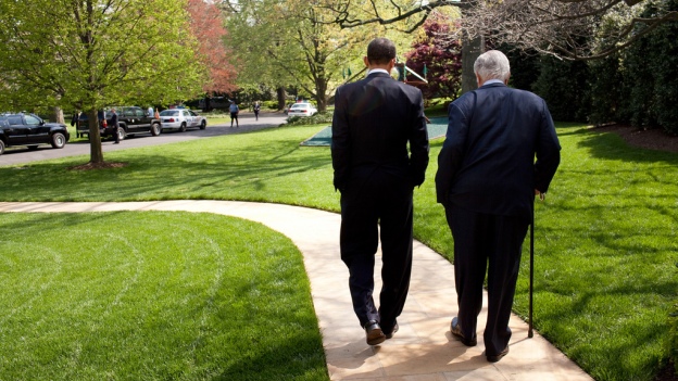 President Barack Obama and Senator Ted Kennedy walk on the grounds of the White House.