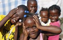 Children pose for the camera in an improvised camp in Port-au-Prince Jan. 27, 2010.