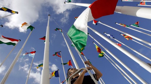 Worker hoists flags of African and European countries in Lisbon, Portugal, Dec. 7, 2007. [AP File]