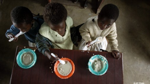 Children eat porridge at an orphanage, Blantyre, Malawi, May 23, 2006. [AP File Photo]