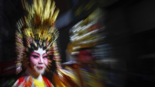 A woman dressed in traditional wear takes part in the 14th annual Chinatown Lunar New Year Parade in New York, February 17, 2013. 