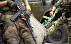 Pro-Russian rebels hold their guns as they patrol the Lenin square in the town of Donetsk, eastern Ukraine