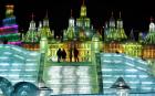 Visitors walk between buildings made out of blocks of ice 