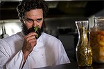 Tyler's owner, Josh Tyler, with some beach spinach at the restaurant in Mogo. He is using locally sourced ingredients to dictate the dinner menus each night.