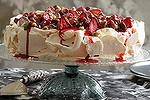 Pavlova with dried strawberries, pistachios and rose water cream.