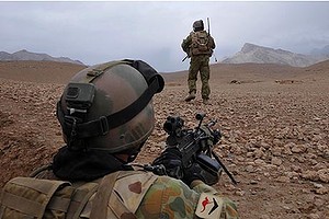 A private manning a F89 machine gun provides cover as members of his platoon move out to check ruins suspected of containing insurgent weapons caches, during Operation Tura Ghar in the Baluchi Valley, southern Afghanistan.