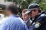 Police lead the 34-year-old lawyer from his Martin Place office.