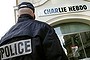 A policeman stands guard outside the French satirical weekly <i>Charlie Hebdo</i> in Paris in this February 9, 2006 file photo. The magazine has been targeted by Islamists before.