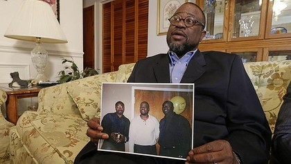 Anthony Scott holds a photo of himself, centre, and his brothers Walter (left) and Rodney, at his home near North Charleston, South Carolina. 