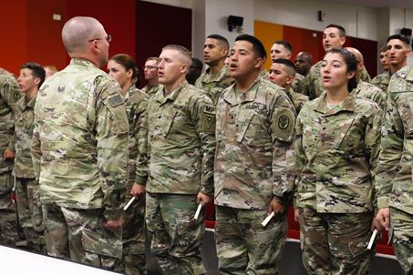 The distinguished honor graduate of Basic Leader Course 706-17 leads his fellow troopers in reciting the noncommissioned officers creed.