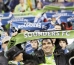 Seattle Sounders fans hold up scarves at the start of the Sounders’ MLS soccer game against the Philadelphia Union in Seattle.