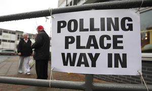 A woman arrives to cast her vote in the Glasgow North East byelection