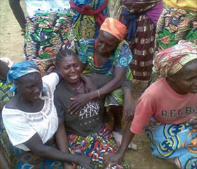 Villagers try to console a mother who lost family to the Muslim Fulani attack in Byei.