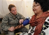 Maj. Shannon Faber checks a patient's blood pressure during a medical assessment.