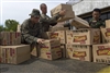 U.S. Marines and Indonesian air force personnel load a pallet of food.