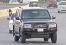 Pakistani journalists follow a vehicle believed to be a British embassy car carrying the recovered Sahil Saeed