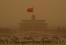 The sand covered Beijing, causing workers and tourists to muffle their faces in vast Tiananmen Square