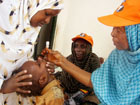 A World Health Organization ,WHO, official gives a dose of Polio Vaccine to Somali child in Mogadishu, Somalia. [AP Photo\Sept. 2006]