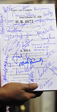 Sheila Jackson Lee holds an autographed copy of the bill after Congress passed the landmark Health Care and Education Affordability and Reconciliation Act