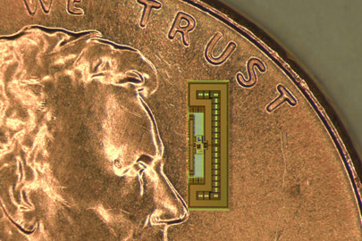 Tiny radio-on-a-chip resting on a penny/Photo: Courtesy of Amin Arbabian
