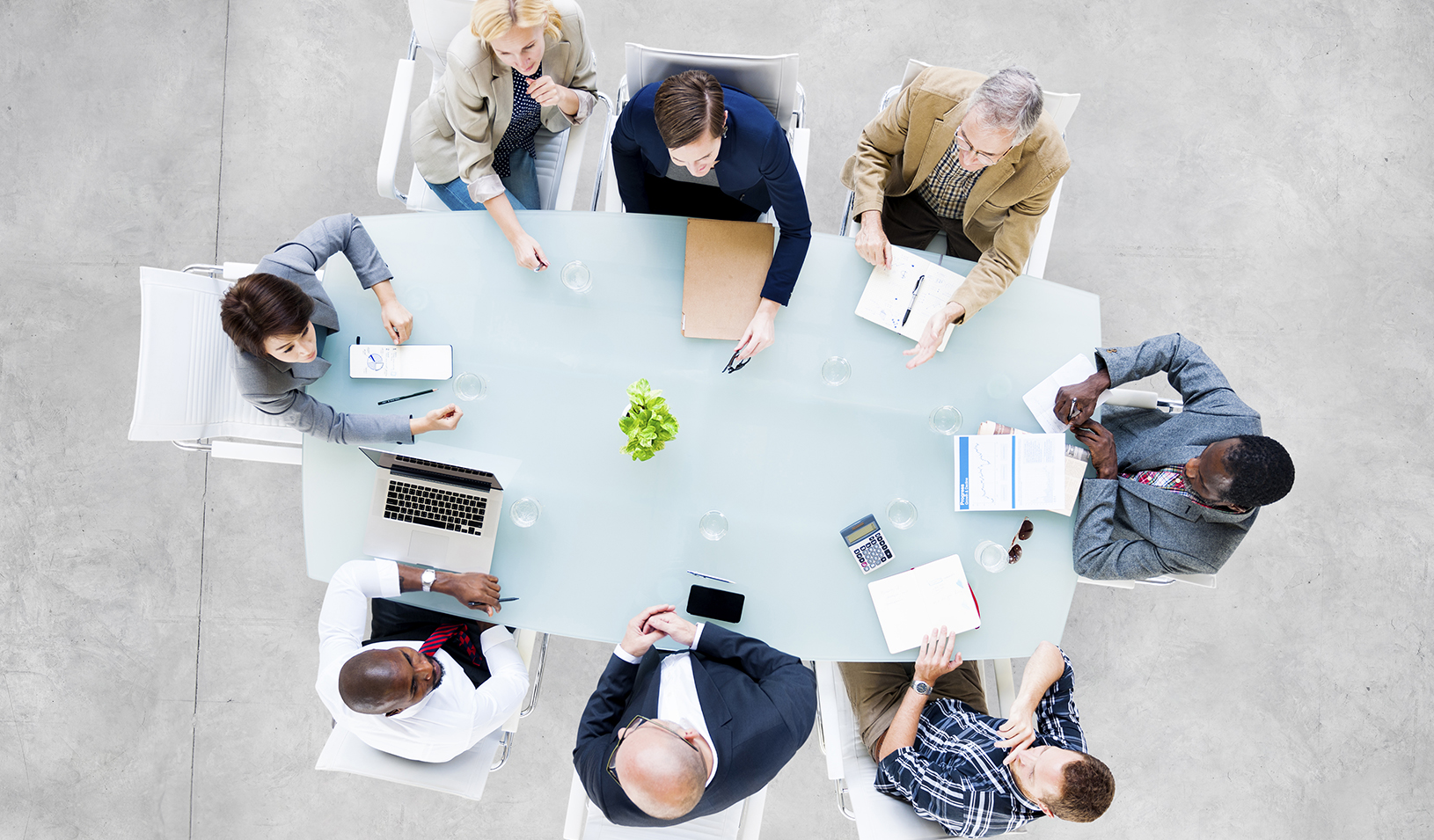 Group of people sitting around a table | iStock/Rawpixel Ltd