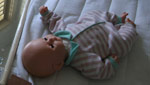 A doll lies on a bed in an orphanage in Aruba