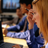 Young business woman in meeting working on laptop