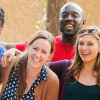 Diverse group of male and female colleagues smiling and laughing together