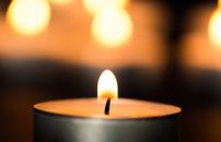 Tea candle lights glowing on wooden table