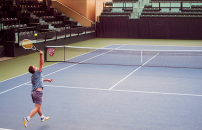 Faculty playing a friendly match on Stanford's tennis court.