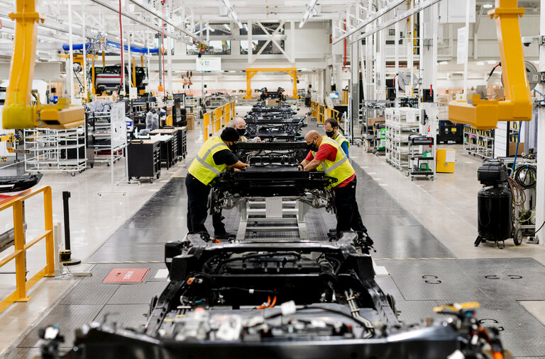 A Rivian assembly line in Normal, Ill. Rivian has raised more than $10 billion, allowing it to splurge on a new plant even before fully using the one it already occupies.