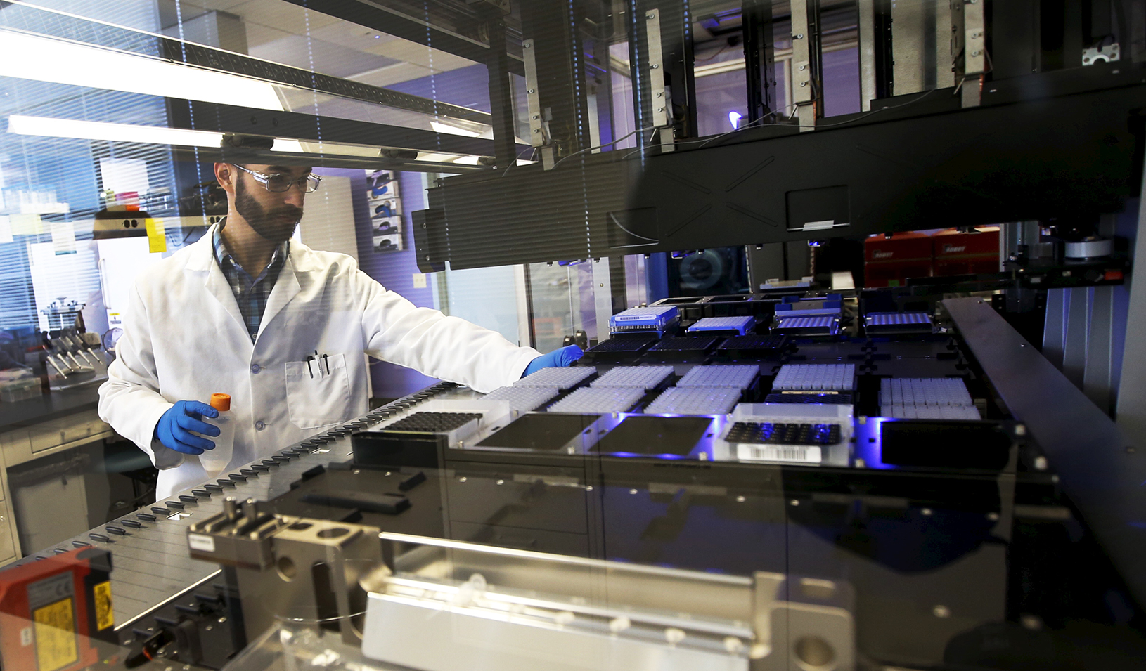 Technician loads a robotic DNA sample automation machine at a Regeneron Pharmaceuticals Inc. laboratory | Reuters/Mike Segar