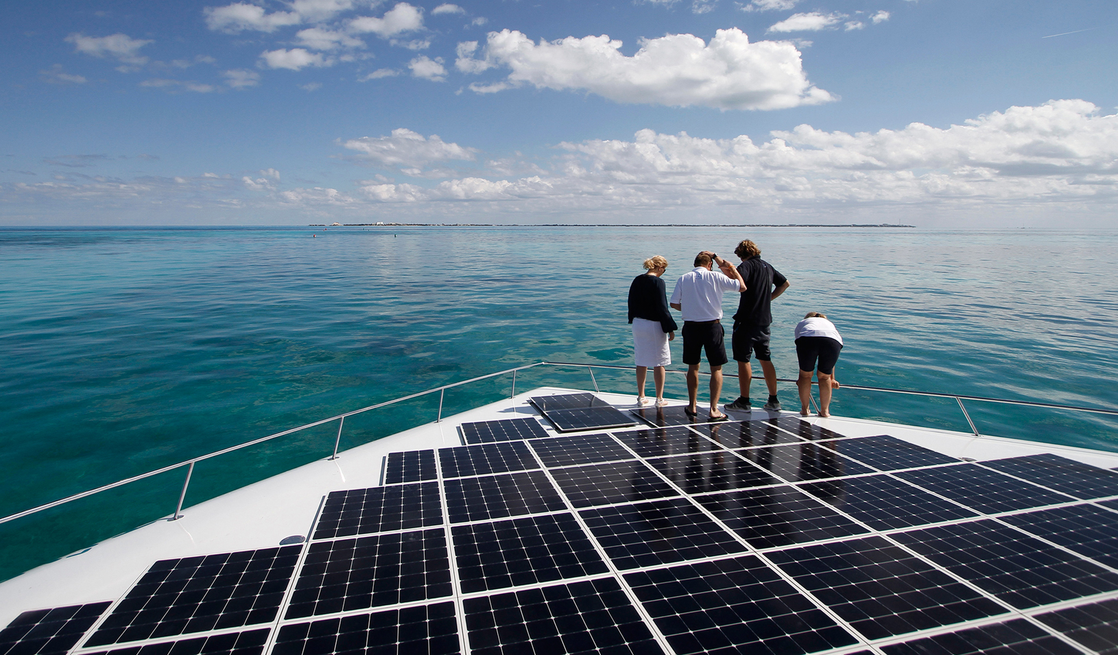 People standing world's largest solar-powered boat