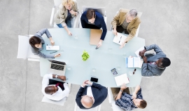 Group of people sitting around a table | iStock/Rawpixel Ltd
