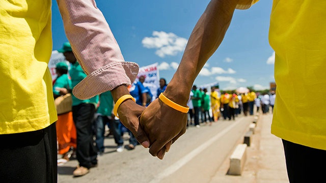 Date: 2016 Description: Men holding hands in Mozambique © PSI