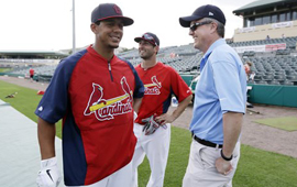 Feb. 25, 2013, file photo of Houston Astros general manager Jeff Luhnow, right, talking to St. Louis Cardinals center fielder Jon Jay, left, and second baseman Daniel Descalso