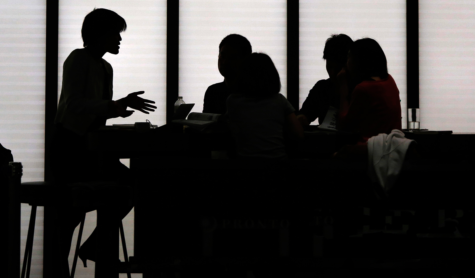 Silhouetted people holding a meeting | Reuters/Yuya Shino 