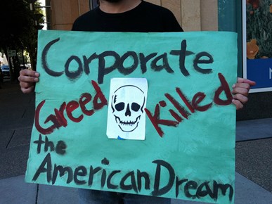 Corporate greed protest sign