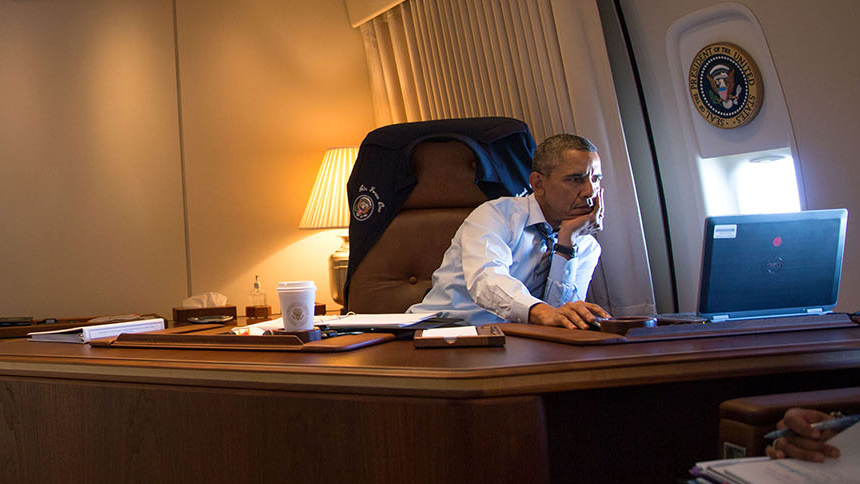 President Barack Obama at his computer aboard Air Force One during the flight to Toluca, Mexico, Feb. 19, 2014.