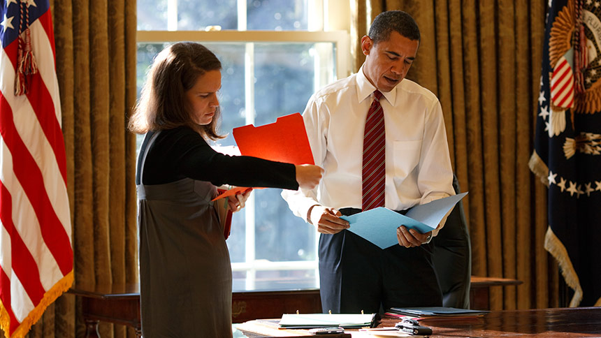 President Obama reviews his schedule and materials for the day