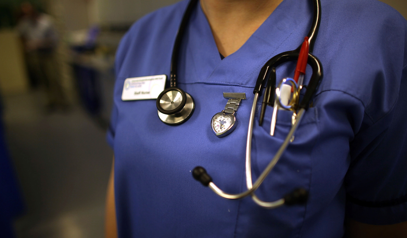 Doctor in scrubs with stethoscope around neck | ©iStock.com/EdStock