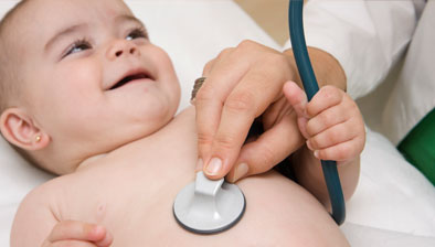 Smiling baby holding stethoscope