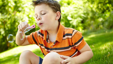 Young boy blowing bubbles