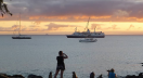 Galapagos sea lions, tourists and residents share the beach at Puerto Baquerizo Moreno