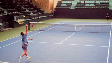 Faculty playing a friendly match on Stanford's tennis court.