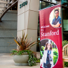 Close up of Welcome Center standing banner in front of 3160 Porter Drive building